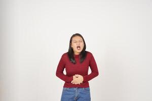 ung asiatisk kvinna i röd t-shirt lidande magont, smärta på mage isolerat på vit bakgrund foto