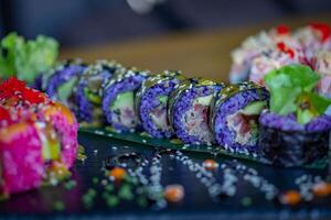 sushi rullar på en svart tallrik, närbild, selektiv fokus foto