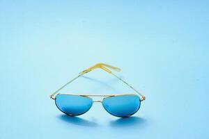 eleganta solglasögon på en blå bakgrund foto