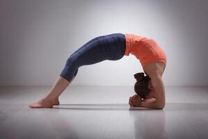 skön sportig passa yogi flicka praxis yoga asana viparita dan foto