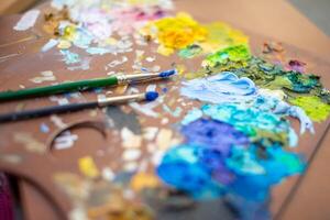 palett med flerfärgad målarfärger och borstar, kvinna målning bild foto