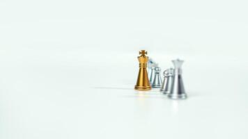 gyllene kung schack på de styrelse i främre av silver- schack bitar på vit bakgrund med kopia Plats, ledarskap, kämpe, företag ledarskap, konkurrens, konfrontation, och företag strategi begrepp. foto