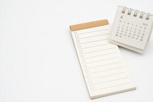 tom kolla upp lista eller tömma små anteckningsblock med kryssruta och enkel skrivbord kalender för april 2024. tom checklista för text. kopia Plats. foto