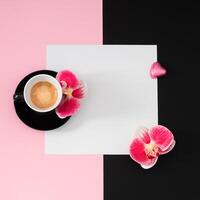 kreativ trendig layout tillverkad med kopp av kaffe, orkide blommor, rosa folie insvept choklad hjärta och papper kort notera kopia Plats på ljus rosa och svart bakgrund. minimal begrepp. platt lägga. foto