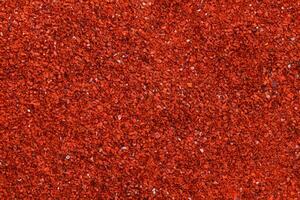 bakgrund textur av chili pulver och röd kajenn peppar. foto
