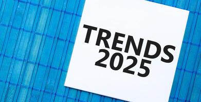trender 2025 notera på blå bambu bakgrund. företag och prognostisering begrepp foto