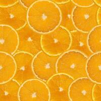 sömlös mönster av ljus saftig orange, skära in i cirklar foto