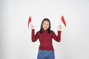 ung asiatisk kvinna i röd t-shirt innehav indonesiska flagga, oberoende dag begrepp isolerat på vit bakgrund foto