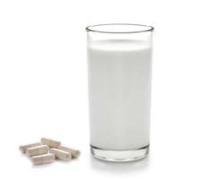 piller och glas mjölk isolerad på vit bakgrund foto
