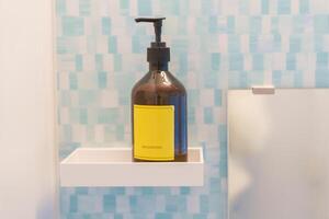 toalettartiklar flaskor i badrum på lyx hotell eller modern Hem. hår schampo behållare med marmor vägg bakgrund foto