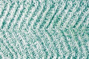 jersey textil- bakgrund , grön vit melange stickat tyg, trasa yta foto