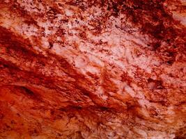 textur av röd sten i trädgården foto