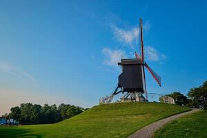 sint-janshuismolen sint-janshuis kvarn väderkvarn i bruges på solnedgång, belgien foto