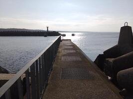 tar en promenad längs de hamn och pir i kolobrzeg, Polen, erbjudanden en härlig erfarenhet med pittoresk visningar av de baltic hav och de livliga havs aktivitet. foto