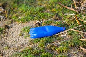 plast flaska på de Strand av de sjö. miljö- förorening. plast avfall på de strand. foto