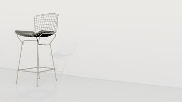 en vit stol med en svart prydnadskudde sitter på en vit vägg foto