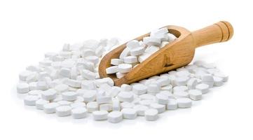 vita piller i skopan på vit bakgrund foto