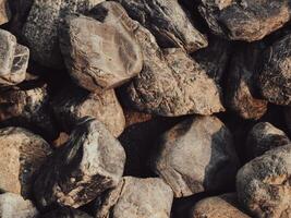 närbild av brun stenar, stark naturlig yta foto