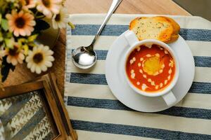 krämig tomat basilika soppa eras i skål isolerat på servett topp se av kinesisk soppa foto