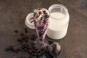 blåbär vanilj is grädde choklad skaka eras i glas isolerat på tabell sida se av friska dryck foto