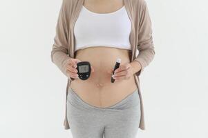 gravid kvinna kontroll blod socker nivå förbi använder sig av digital glukos meter, hälsa vård, medicin, diabetes, glykemi begrepp foto