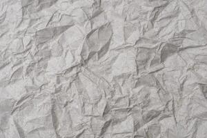 grå skrynkliga ki kraft papper textur bakgrund. de gammal rynkig hantverk papper bakgrund för återvinning foto
