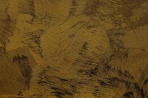 textur av gyllene dekorativ plåster eller betong. abstrakt guld grunge bakgrund. foto