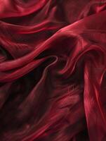 lyxig djup röd satin silke tyg, elegant draperad med mjuk, slät texturer och rik veck. foto