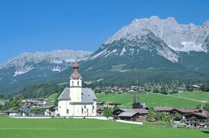 populär idyllisk by av gående am vilda kaiser med kaisergebirge bergen i bakgrund, tirol, Österrike foto