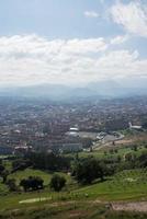 vacker flygfoto över oviedo. gröna fält och berg runt staden. solig dag, inga människor. asturien foto