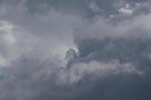 clouds landskap, mulen väder ovan mörk blå himmel. storm moln flytande i en regnig tråkig dag med naturlig ljus. vit och grå naturskön miljö bakgrund. natur se. foto