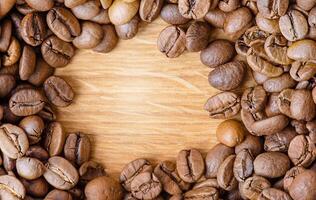 rostad kaffe bönor på en trä- bakgrund. kaffe som bakgrund. foto