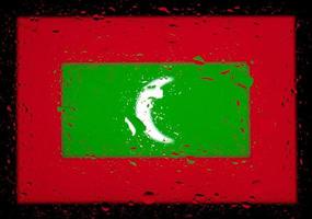 droppar vatten på maldivernas flagga bakgrund. kort skärpedjup. selektiv fokusering. tonad. foto