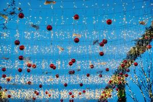 ny år eller jul festlig bollar och kransar hängande i rader mot de natt himmel. foto