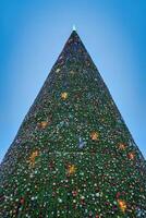 artificiell jul träd i kransar på skymning. foto