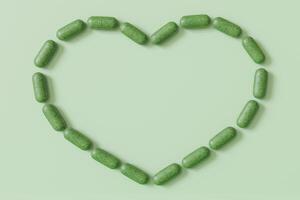 ört- kapslar formning en hjärta form på en ljus grön bakgrund, en kreativ visa för wellness och naturlig tillägg begrepp. homeopati. kopia Plats för text. 3d framställa. foto