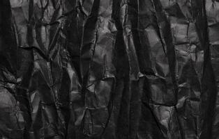 svart skrynkliga papper textur, grunge bakgrund foto