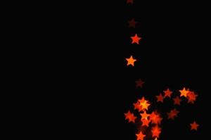 ljus orange stjärna ljuseffekt isolerade overlay glitter textur på svart. foto