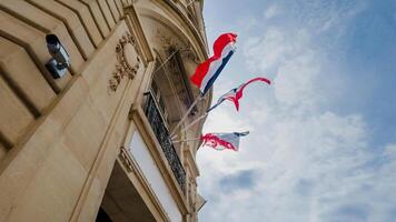 franska och europeisk union flaggor fladdrande mot en blå himmel på en regering byggnad, symboliserar bastille dag och europeisk enhet, lämplig för nationell fester foto