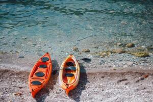 par av färgrik kajaker vilar på de Strand, vinkar äventyrare till utforska dold vikar foto