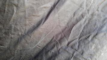 en svart färg tyg mönster textur bakgrund. närbild av vacker rynka svart tyg textur. foto