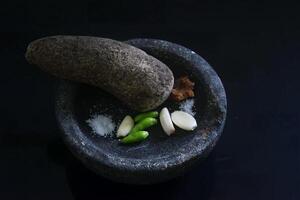 göra grön chili blandad med vitlök använder sig av indonesiska Utrustning kallad layah foto