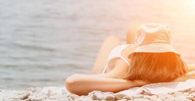 oigenkännlig positiv kvinna i vit bikini solbad eller garvning på havet strand under sommar. långsam rörelse av Lycklig turist njuter Sol solbränna liggande på strand stol vardagsrum på lyx tillflykt foto