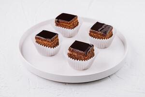 choklad glaserad mini kakor på vit tallrik foto