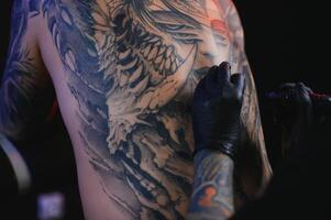 professionell tatuering konstnär gör en tatuering foto