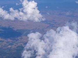 antenn se av berg, himmel och moln sett genom flygplan fönster foto