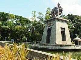 surakarta, central java, indonesien april 11, 2024. de staty av herr Soekarno Sammanträde medan läsning en bok, staty av de först president av de republik indonesien på manahan stadion. foto