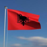 albania flagga är vinka i främre av en blå himmel med suddig moln i de bakgrund foto