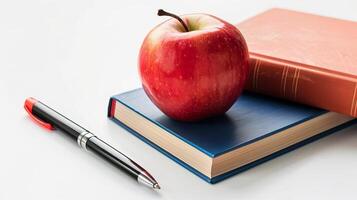 äpple och fyra böcker och en penna på en vit bakgrund med en plats för text foto
