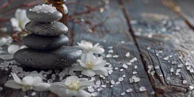 en stack av stenar och några vit blommor på en trä- tabell foto